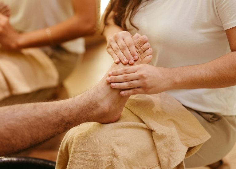 Photo by Jonathan Borba Close-up of a foot massage in a spa setting, highlighting relaxation and wellness.